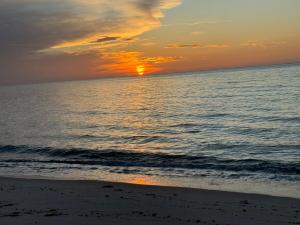a sunset on the beach with the ocean at Oceanfront retreat, Hollywood Beach ,Miami Florida in Hollywood