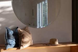 a mirror sitting on top of a shelf with pillows at Sea Notes Yamba in Yamba +48 photos
