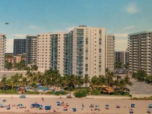 a group of people on a beach in front of buildings at Oceanfront retreat, Hollywood Beach ,Miami Florida in Hollywood