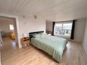 a bedroom with a bed and a large window at Iceberg Lookout in Twillingate +12 photos
