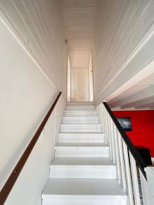 a staircase in a building with white stairs at Iceberg Lookout in Twillingate