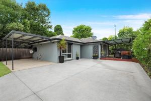 a detached house with a large driveway at Belle in Bowral in Bowral
