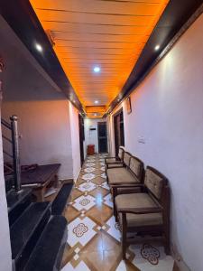 a row of chairs in a room with a ceiling at Samriddhi UrbanStay in Ayodhya