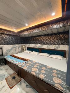 a bedroom with two beds in a room at Samriddhi UrbanStay in Ayodhya