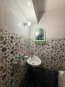 a bathroom with a sink and a mirror at Samriddhi UrbanStay in Ayodhya