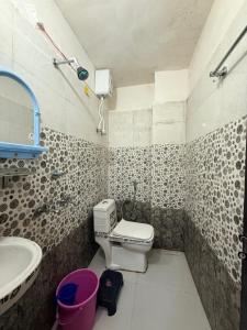 a bathroom with a toilet and a sink at Samriddhi UrbanStay in Ayodhya +15 photos