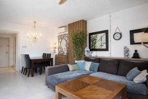 a living room with a couch and a table at Attic Center Sitges in Sitges
