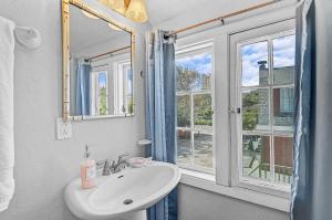 a white bathroom with a sink and a window at The Reserve Retreat in Sarasota