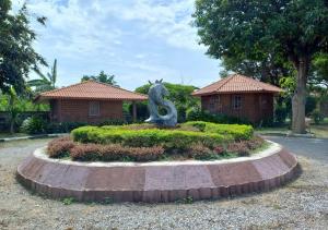 a statue of a letter s in front of a house at สายชลวิว ริเวอร์แคว in Ban Wang Yen