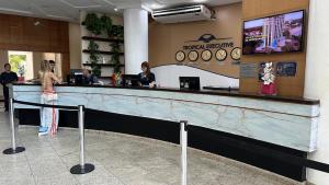 a woman standing at a counter in a restaurant at Tropical Executive 924 in Manaus +27 photos