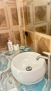 a white sink in a bathroom with wooden walls at Pakmeng Beach Resort in Pak Meng +36 photos
