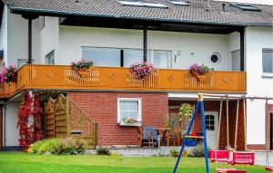 a house with an orange balcony with flowers on it at Beautiful Apartment In Reifferscheid in Reifferscheid
