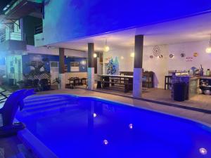 a large swimming pool in a room with a house at AP mobiliado em Guaibim in Guaibim