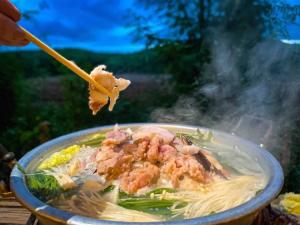a bowl of soup with shrimp and noodles on a table at Homestay with Rive View Bann Good View in Ban Hua Phrong