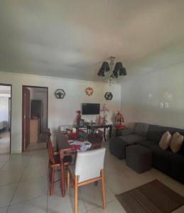 a living room with a couch and a table at Casa temporada frances in Marechal Deodoro