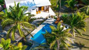 an aerial view of a villa with a swimming pool and palm trees at Ecohotel Kocoluu in San Bernardo del Viento