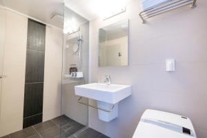 a bathroom with a sink and a toilet and a mirror at 진우 프레스티지 호텔 in Okp'o-ri +22 photos