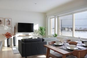 a living room with a couch and a table at Akayane Lodge by H2 Life in Nakafurano