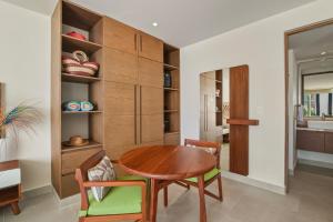 a dining room with a wooden table and chairs at Akumal Cielo Seven Ocean View Pools Beach Access in Akumal +34 photos