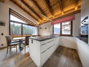 a kitchen with a sink and a dining room with a table at Luxury alpine chalet in Neukirchen in Neukirchen am Großvenediger