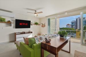 a living room with a couch and a table at Akumal Cielo Seven Ocean View Pools Beach Access in Akumal