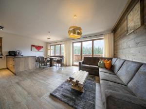 a living room with a couch and a table at Chalet in Neukirchen for 8 people in Neukirchen am Großvenediger