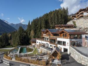 an aerial view of a resort with a pool and mountains at Chalet in Neukirchen for 8 people in Neukirchen am Großvenediger