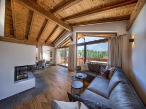 a living room with a couch and a fireplace at Chalet with sauna, Neukirchen in Neukirchen am Großvenediger