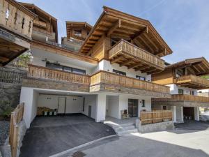 a large building with wooden balconies on it at Chalet with sauna, Neukirchen in Neukirchen am Großvenediger