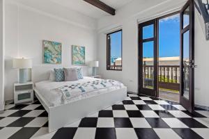 a white bedroom with a bed and a checkered floor at Mint Suite - 1 BR in Old San Juan in San Juan