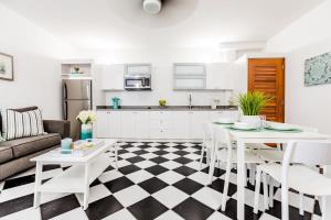 a kitchen and living room with a table and chairs at Mint Suite - 1 BR in Old San Juan in San Juan