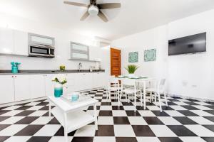 a kitchen with a black and white checkered floor at Mint Suite - 1 BR in Old San Juan in San Juan