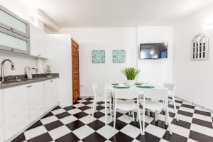 a white kitchen with a black and white checkered floor at Mint Suite - 1 BR in Old San Juan in San Juan +17 photos
