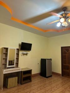 a living room with a ceiling fan and a television at Phu Lanta Life Resort in Ko Lanta +60 photos