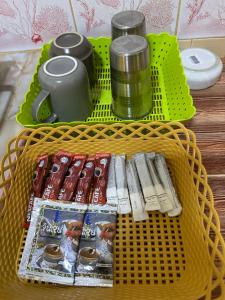 a yellow basket with magazines and drinks on a table at Phu Lanta Life Resort in Ko Lanta