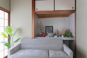 a living room with a couch and a table at Ao by Perch Japan in Nagoya
