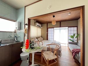 a kitchen with a bed and a table in a room at Ao by Perch Japan in Nagoya