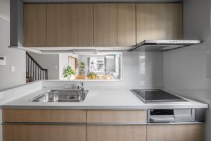 a kitchen with a sink and a stove at The KAMUY FURANO in Nakafurano