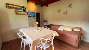 a bedroom with a bed and a table and chairs at Complejo de cabañas Vida Paz in Las Calles