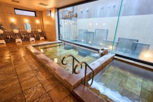 a pool of water in a room with a spa at Hotel Lexton Kagoshima in Kagoshima