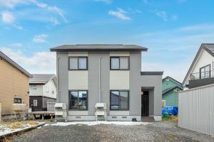 a house with two chairs in front of it at The KAMUY FURANO in Nakafurano