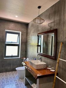 a bathroom with a sink and a mirror at Ocean House An Bang in Hoi An