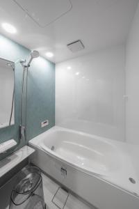 a white bathroom with a tub and a sink at The KAMUY FURANO in Nakafurano +126 photos
