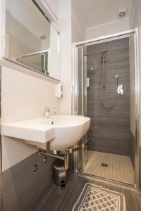 a bathroom with a sink and a shower at Albergo Ristorante Pozzi in Bellaria-Igea Marina