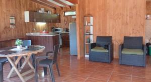 a kitchen and dining room with a table and chairs at Casa cerca de lago Caburgua in Pucón