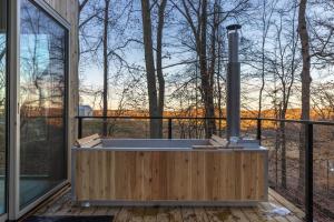 a hot tub on a deck with a large window at The Primrose in Logan