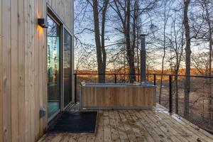 a hot tub on the deck of a house at The Primrose in Logan