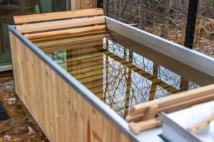 a wooden fence with a reflection in the water at The Primrose in Logan