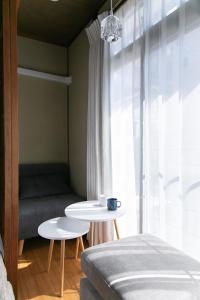 a living room with a couch and a table at Ao by Perch Japan in Nagoya