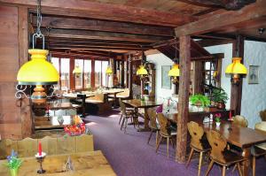 a restaurant with tables and chairs in a room at Hotel Brienzerburli in Brienz